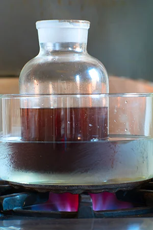 To speed the dissolving process, the ambergris tincture is heated in a water bath.