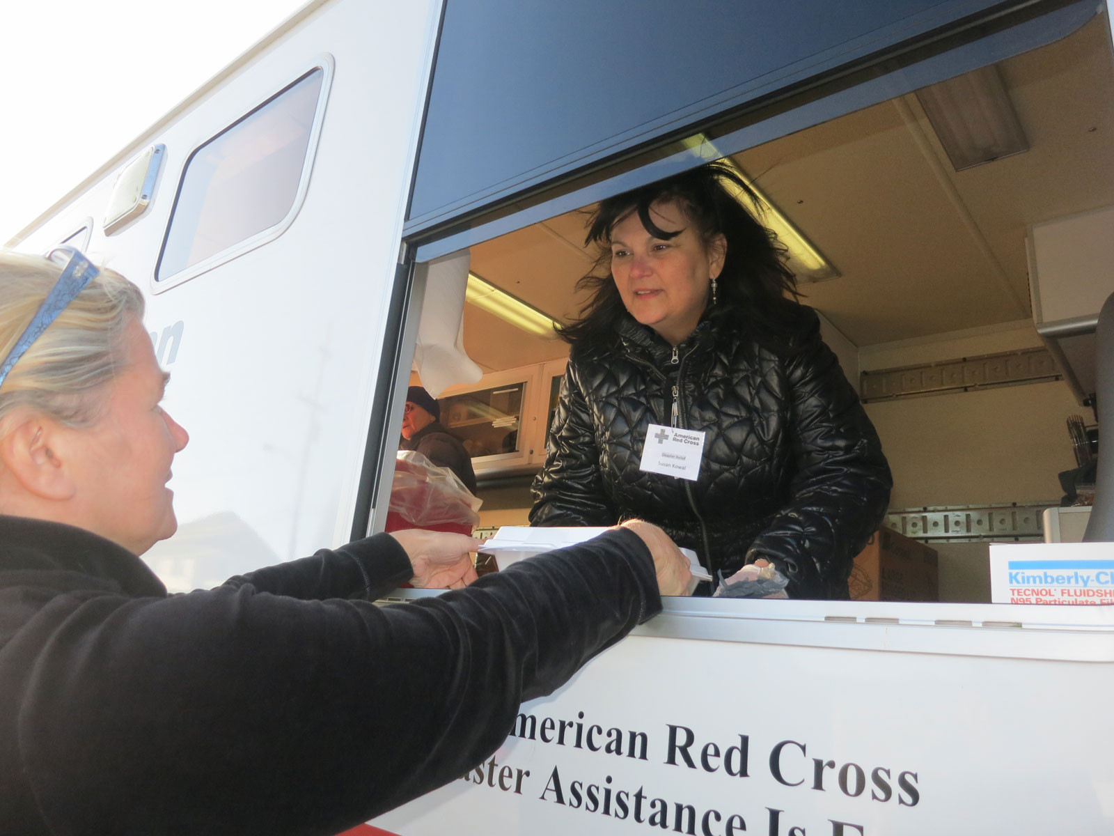 Susan Kowal serving hot turkey, string beans, mashed potatoes with gravy, apple sauce and a snack pack of goodies and water from the window in the side of the Red Cross truck known as an ERV (Emergency Response Vehicle). Families were even given a Thanksgiving table cloth but the best gift is sometimes just compassion or chance to talk about each situation.
