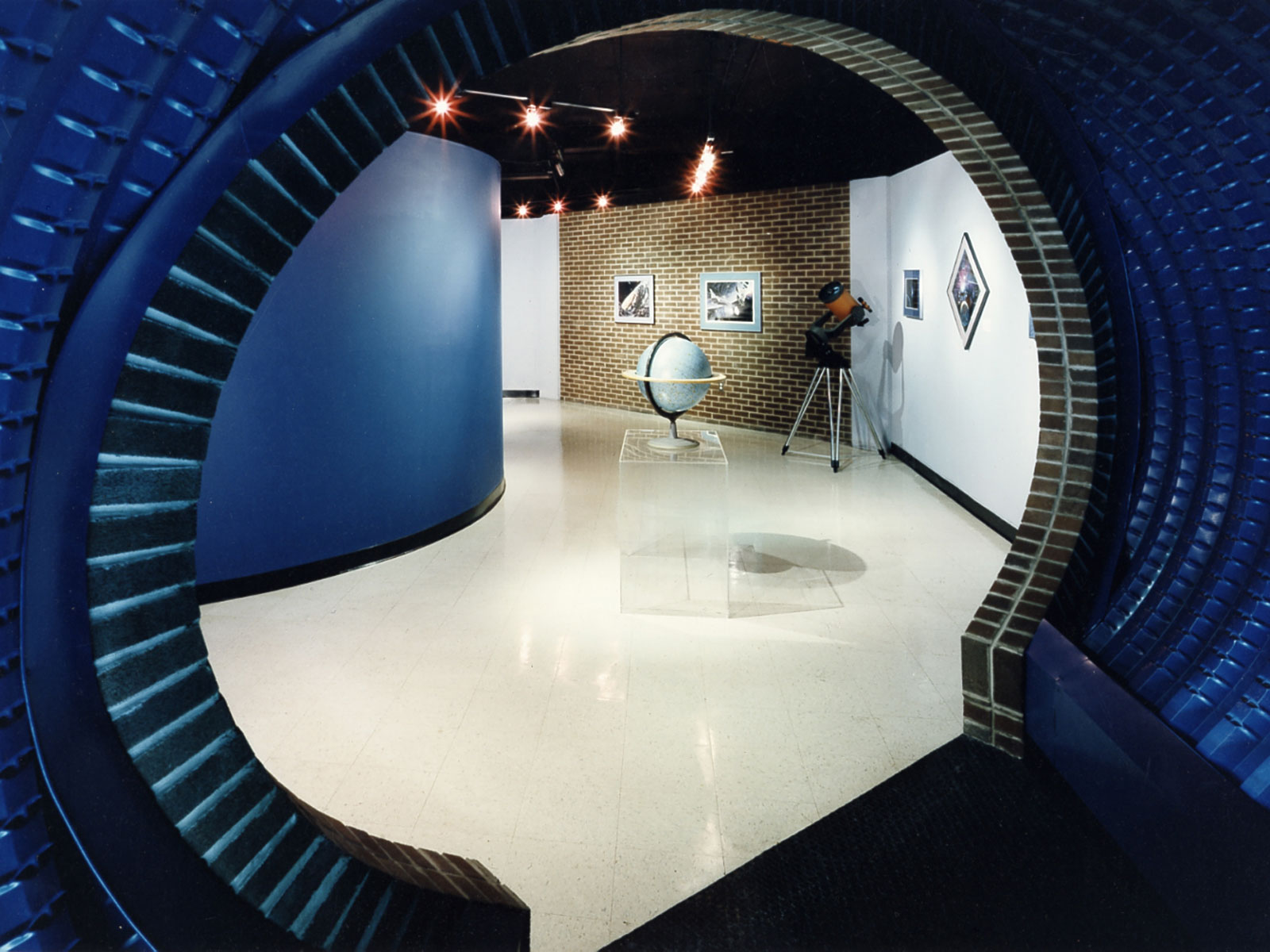 The floor plan is designed in a series of orbits circulating visitors through the lobby, tunnel, museum, and planetarium.