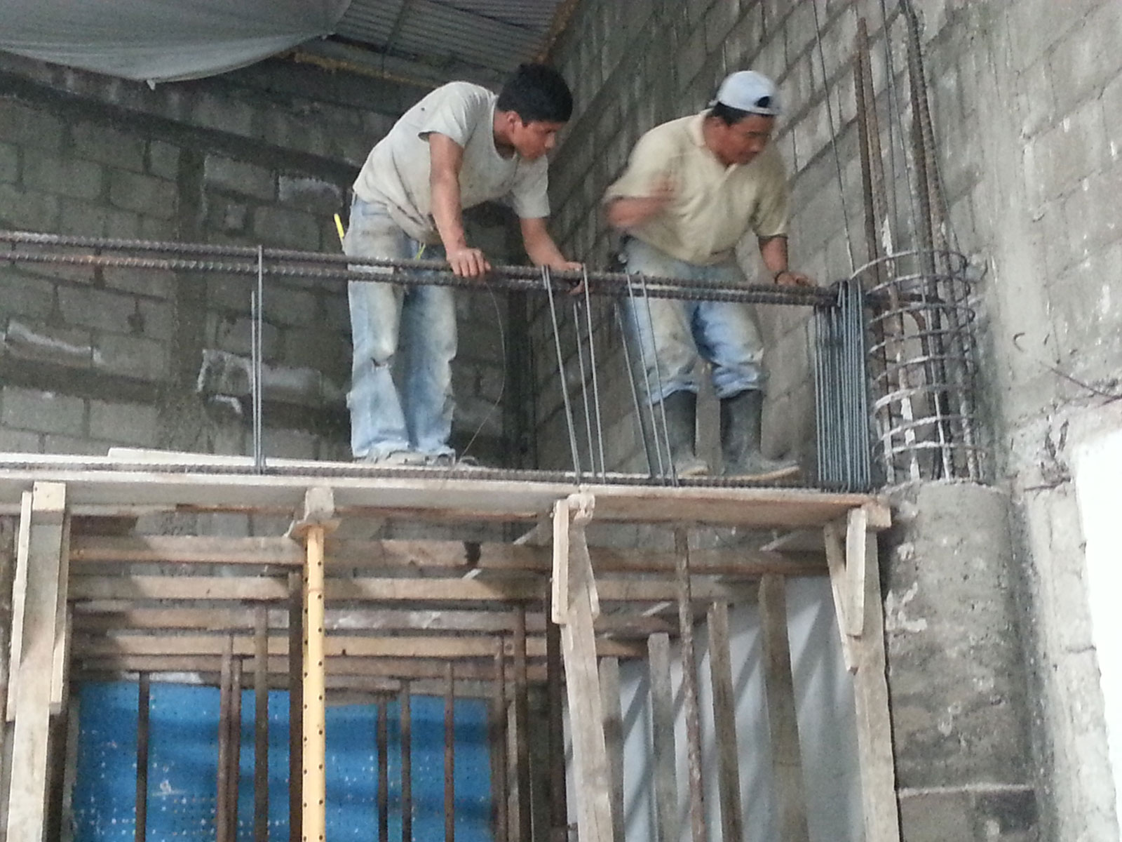 Workers at the Genesaret Church in Guatemala City begin reinforcement of the two story walls to accommodate a second floor. A combination of rebar, poured concrete and block walls provides earthquake protection and added security against intrusion.