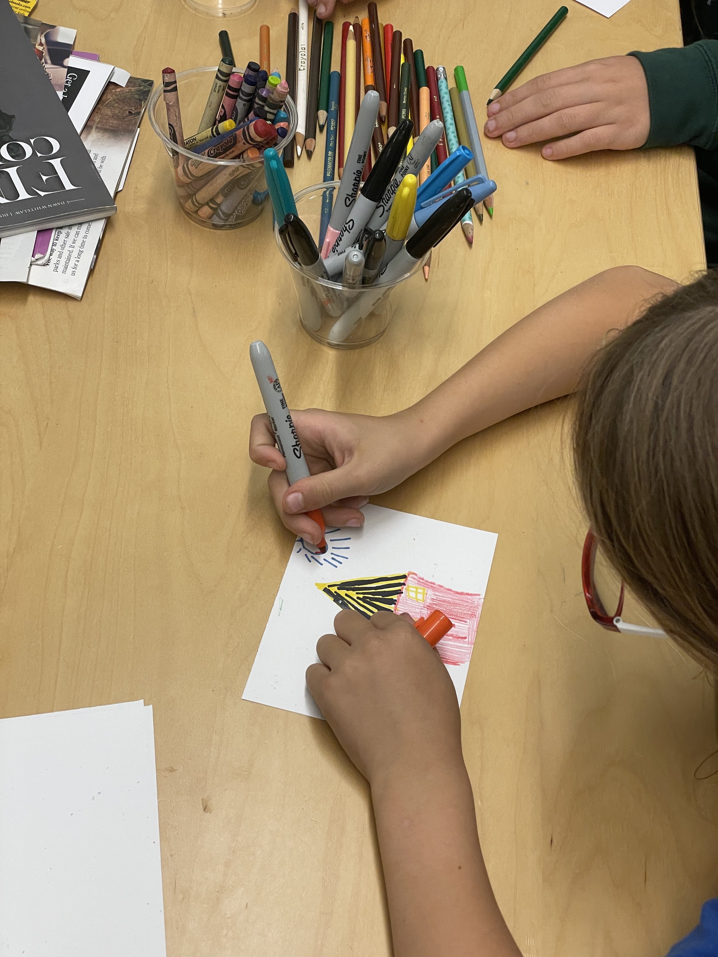 A child drawing a postcard