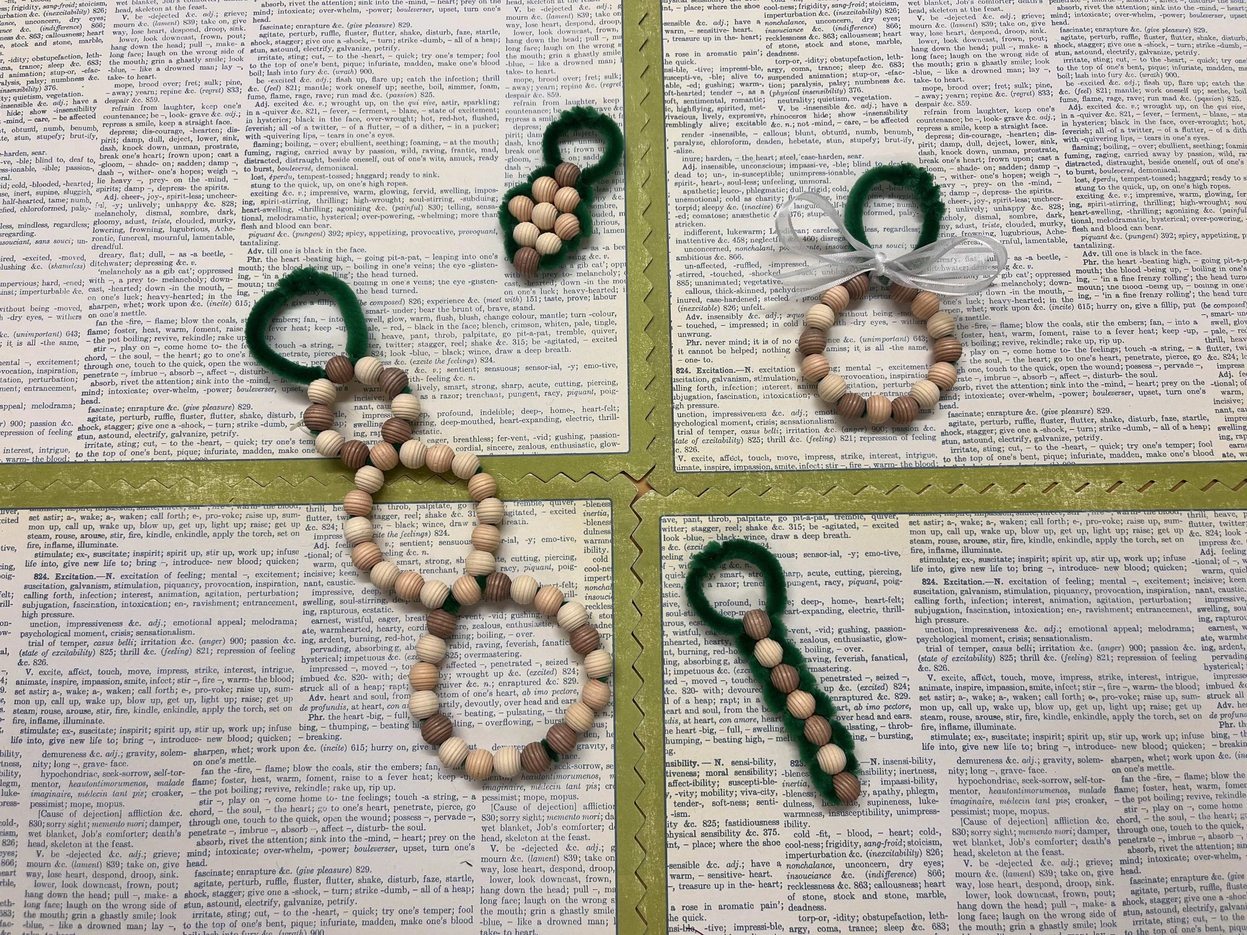 A beaded wreath, snowman, diamond, and line