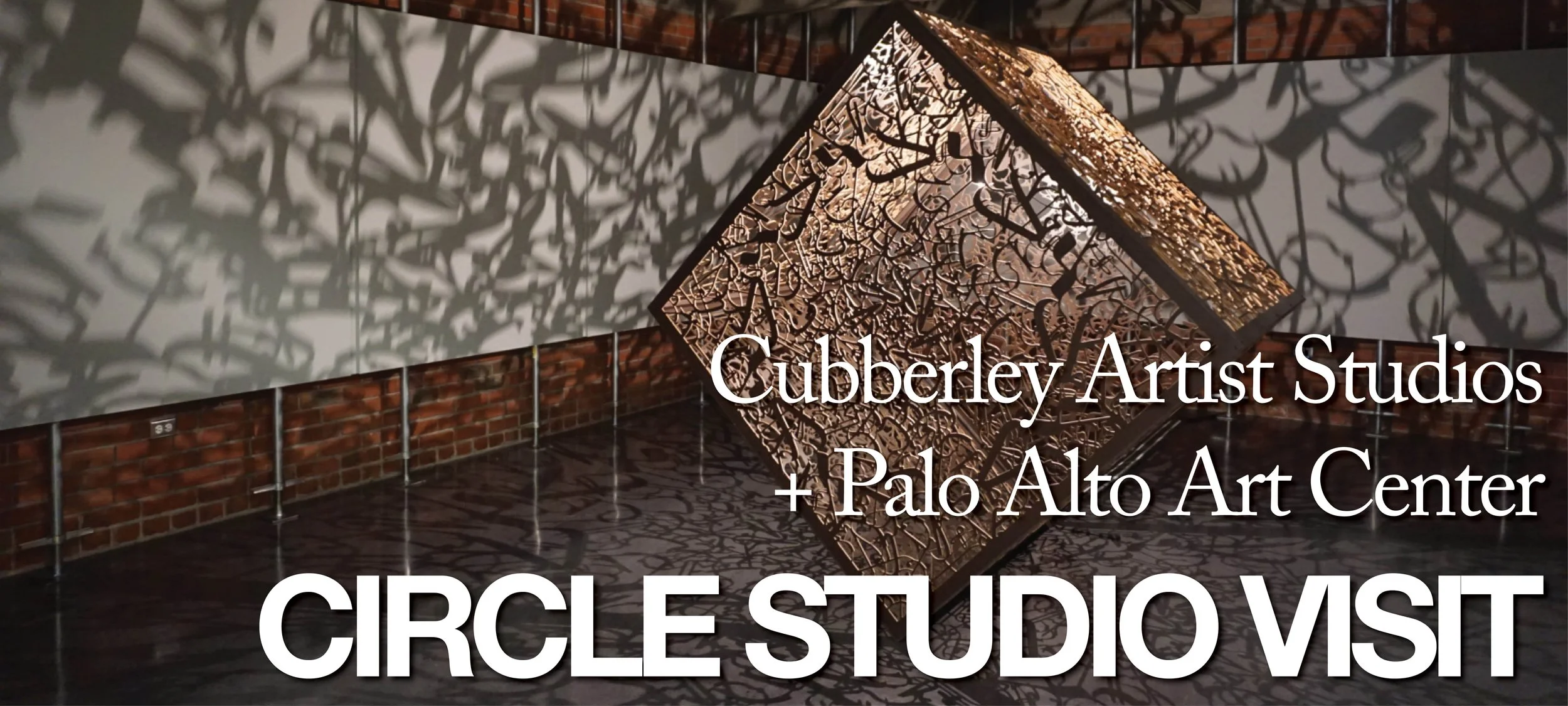 On Edge, a large cube with spiraling illegible text on the edges, casting shadows across the room