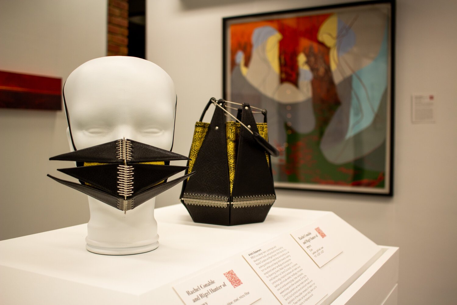Display of a Leather Mask on a Mannequin's Head alongside a Leather Purse