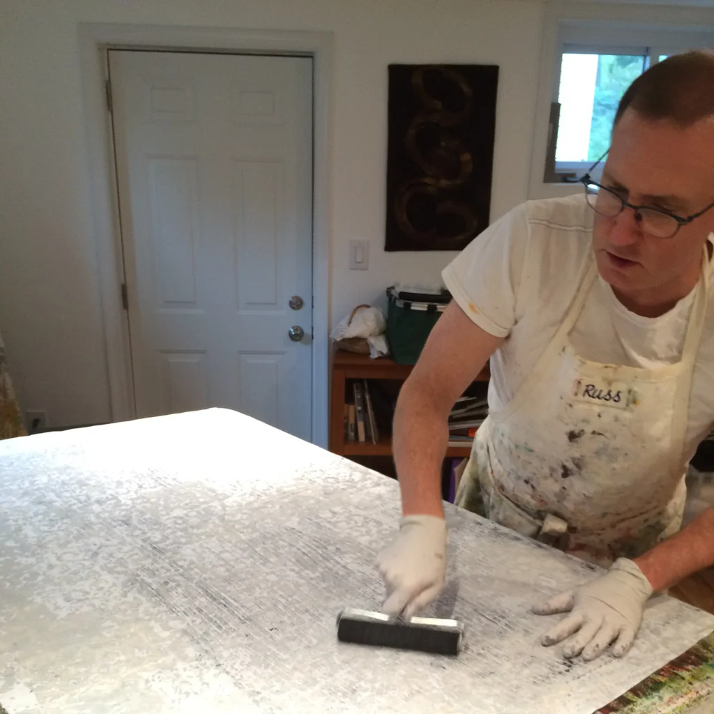 Printing the waxed cloth on inked plate.