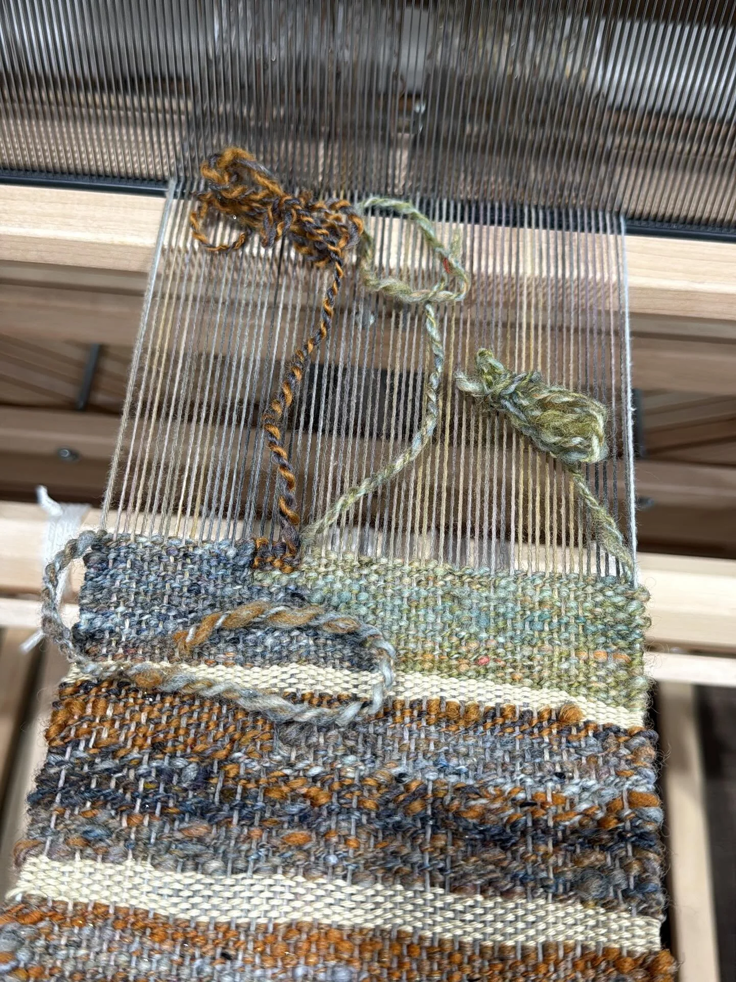 I&rsquo;m dividing my studio time between spinning to build up my yarn stash and practicing my pseudo tapestry weaving technique on this sample warp. I say &ldquo;pseudo&rdquo; because I&rsquo;m not sure that I&rsquo;m going to pack the weft as one w