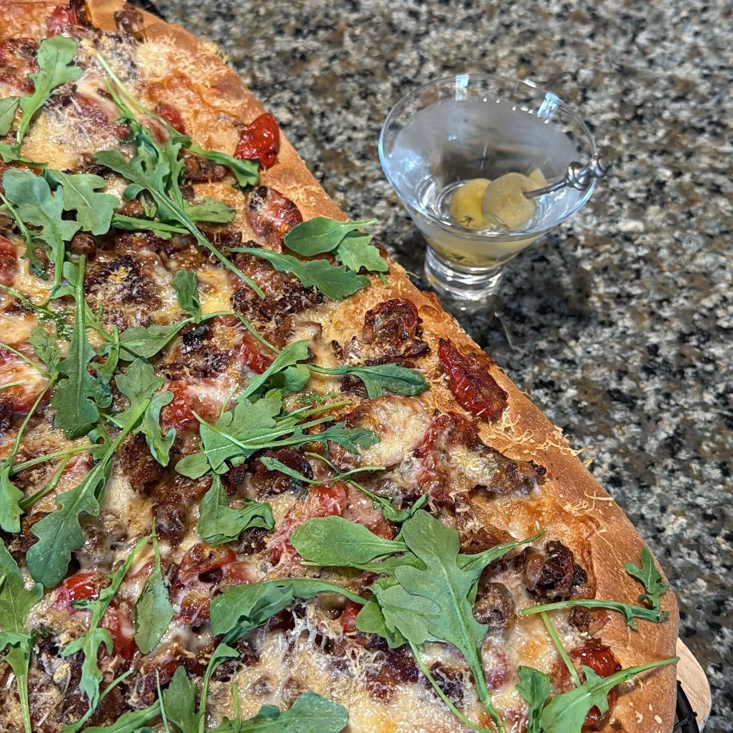 Whole wheat focaccia with oven roasted grape tomatoes, sun dried tomatoes, bacon, cheese, and wilted arugula, plus a cook&rsquo;s treat for 2 1/2 hours of cooking. #martini #focacceria #eatathome