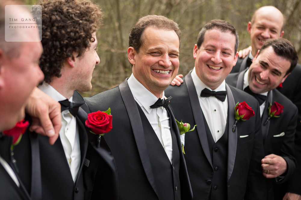  We just love how the rich color in the red rose boutonnieres really pop in this candid groomsmen photo!  