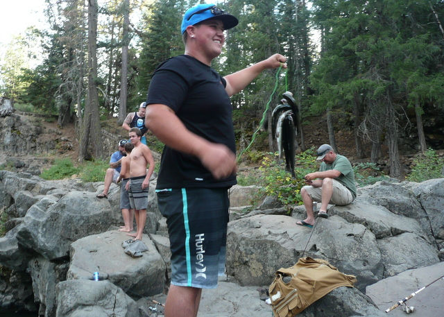 Young men were catching fish at the large pool below the falls.