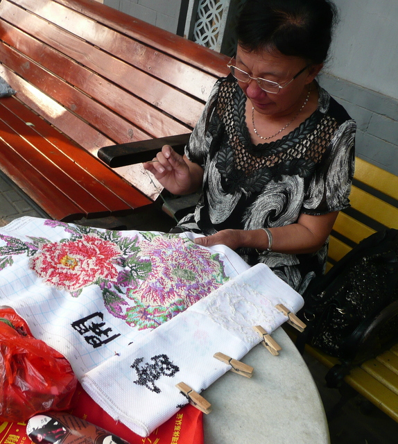 A hutong resident with her needlepoint hobby.