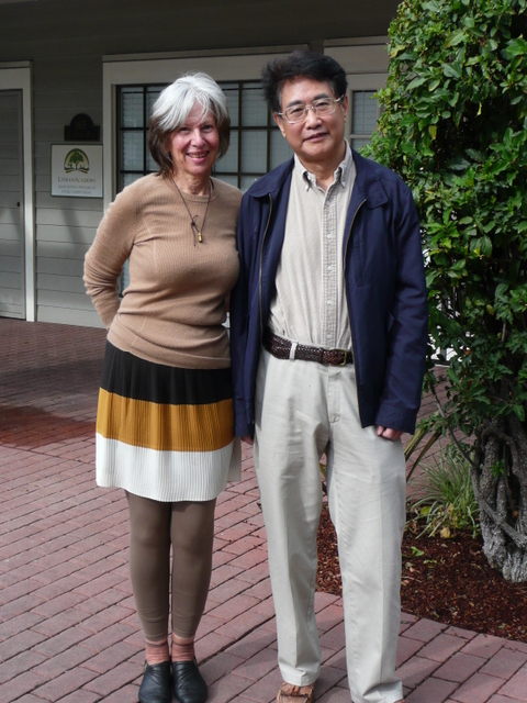 Sha Li and Qiu Xiaolong pose for selfies at Starbucks in Palo Alto, California.