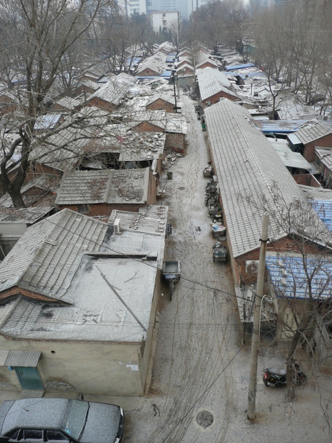 The rooms the traffickers rented in the siheyuan extend east, just inside the wall separating the campus from the new apartments on Chengfu Road. The men struggle to drag Rick’s body into and through a train of adjoining rooms to the last one. This choice of a hideout, near the LiNai Apartments, was perfect for surveilling Rick and Mai. Now that they have the captive, they remove plywood covering another door in the last room, leading to a vacant storage shed on the corner of the hutong directly beneath Mai’s apartment and adjacent to the car gate. They throw him on a mattress in the cold room and shut him in alone. He lies there, not moving, breathing irregularly. A black bag covers his head. His powerful arms are tied behind with zip ties, as are his ankles. His mouth is taped shut.