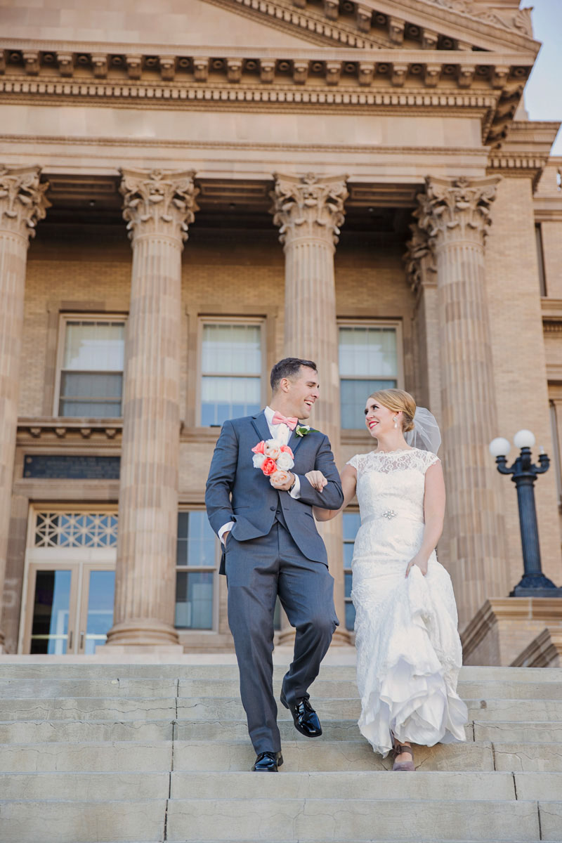 Bride and groom walk down stairs