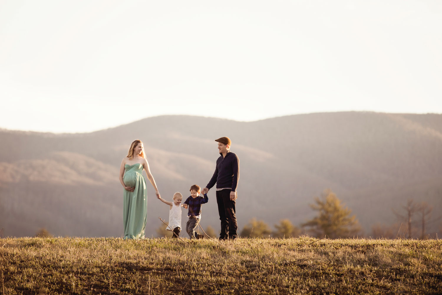 Family poses in Cades Cove for family pictures.