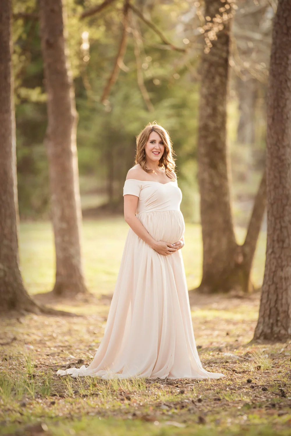 Wooded forest maternity picture in chiffon maternity gown. 