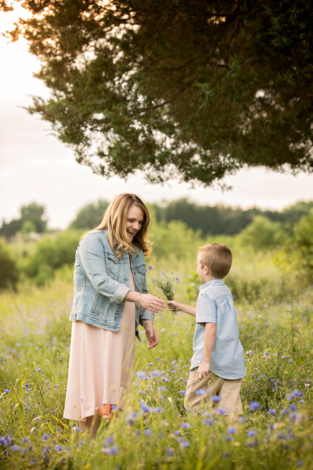 Little boy give Mom wildflower bouquet during Knoxville family photogtaphy session.