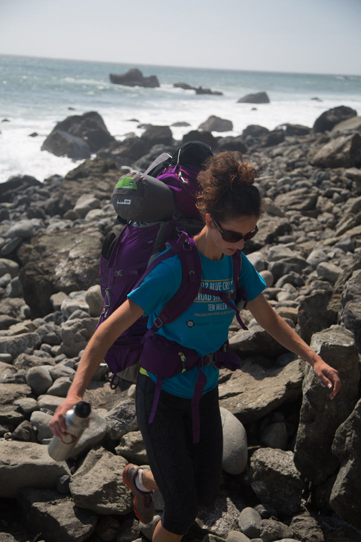 Picking her way through the rocks.