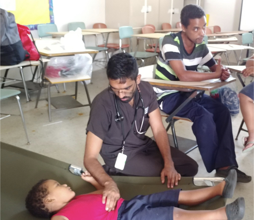 Dr. Avinash Viswanath examining a child in one of many shelters used by residents displaced from homes