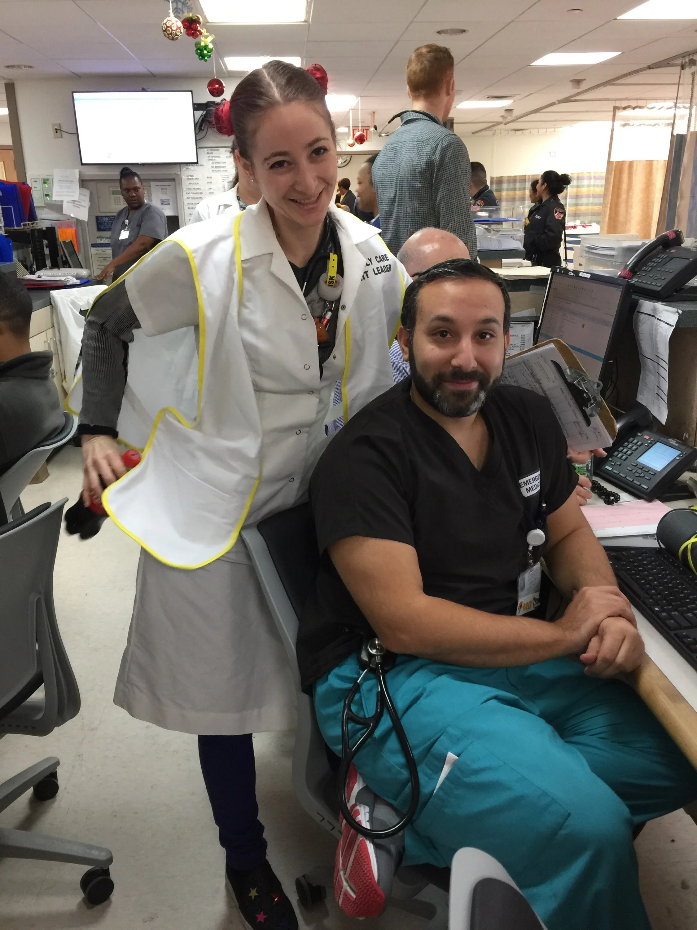 Dr. Ambert forcing a smile onto Dr. Butel's usually stolid mien (both of those words can be your Word-of-the-Day)