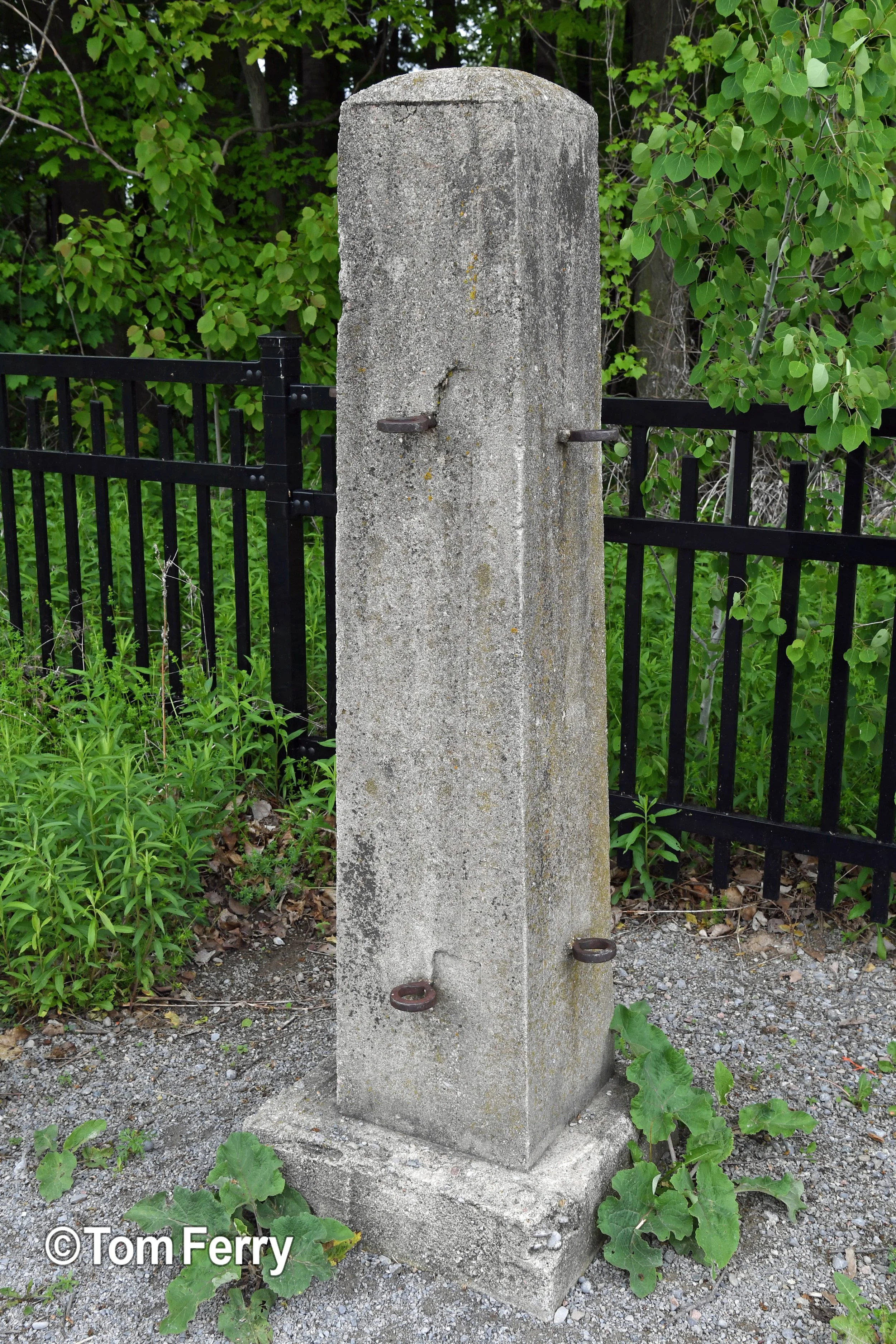 A concrete post from the original farm now sits at the entrance of the Trillium Cemetery.