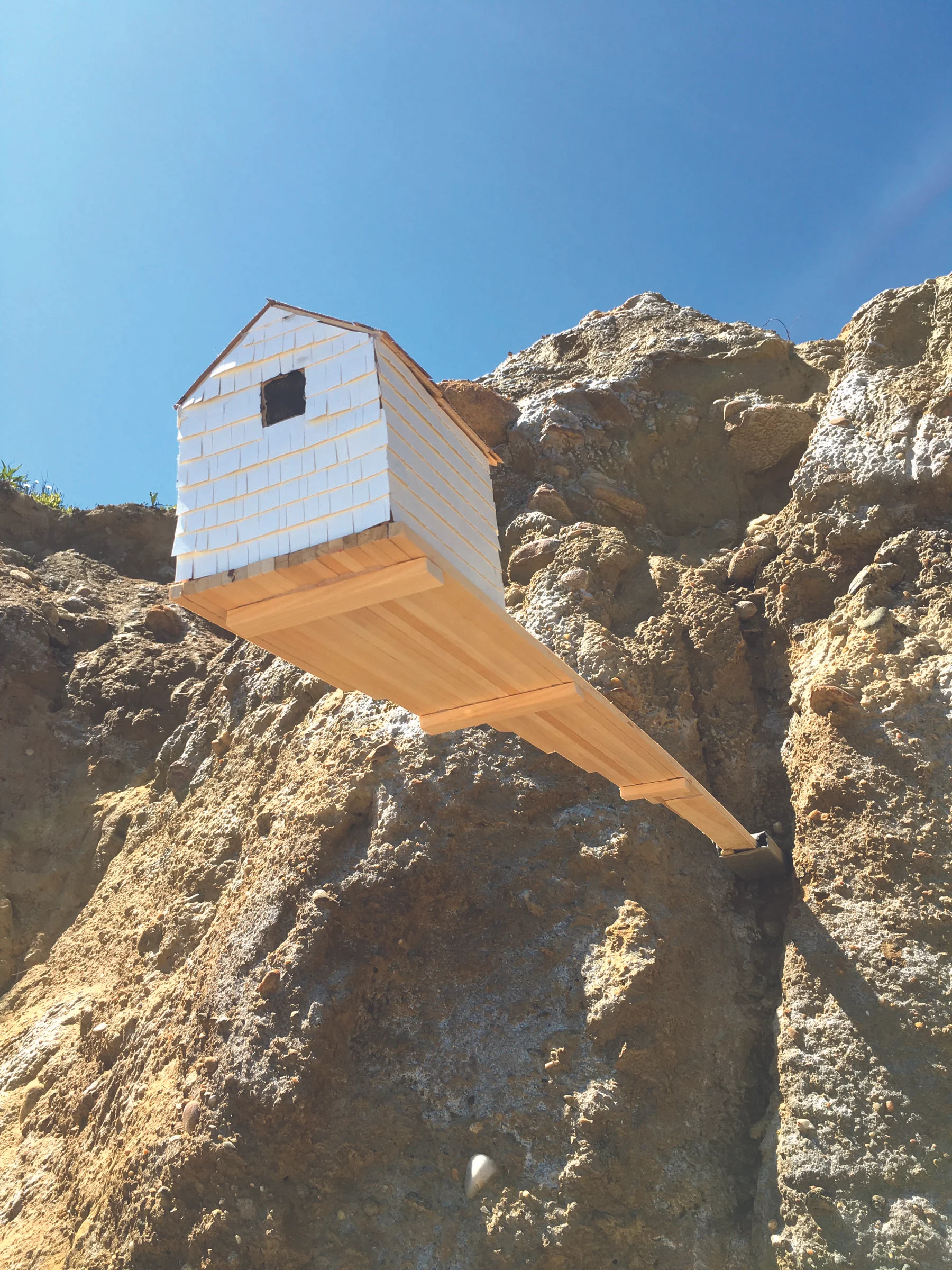 Cliff Cottage wood veneer, wood, sandpaper, metal 5' x 6.5" x 5.5" 2016 on location at Amsterdam Beach, Montauk, NY. June 2016 (Available as archival digital print, 16" x 20", edition of 50)
