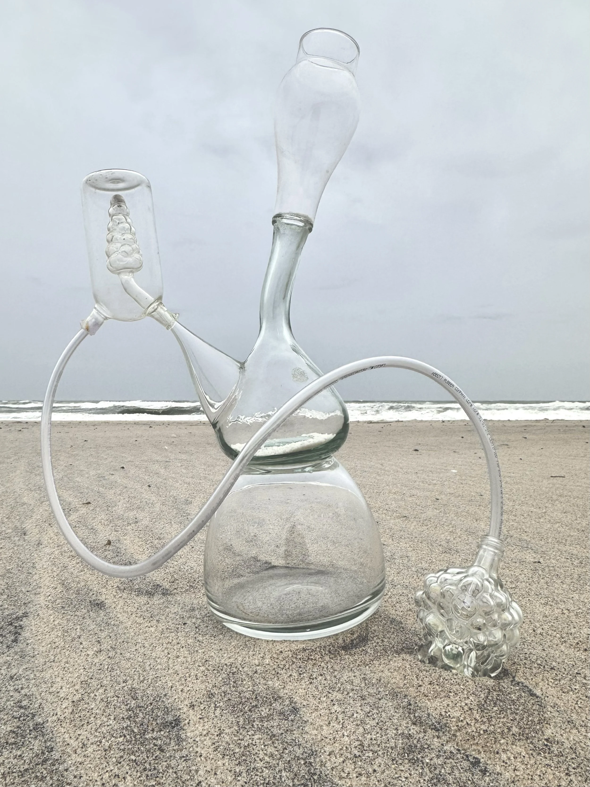    Ormus Generator    found glass and plastic object assemblage  30” x 12” x variable  2025  (available)     