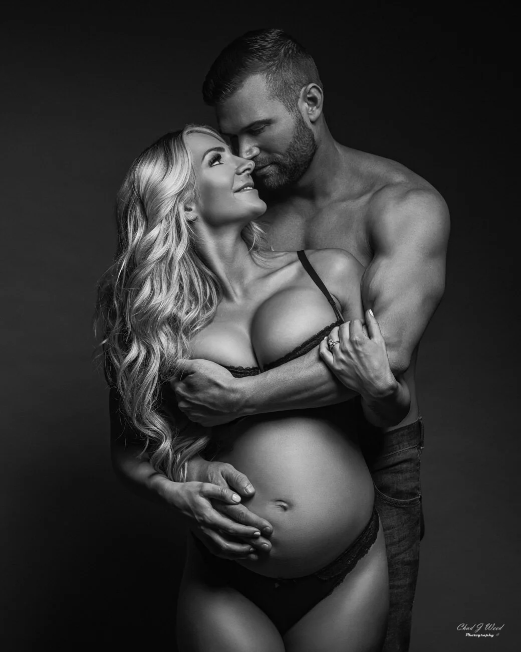 Embracing from behind maternity couple photography pose