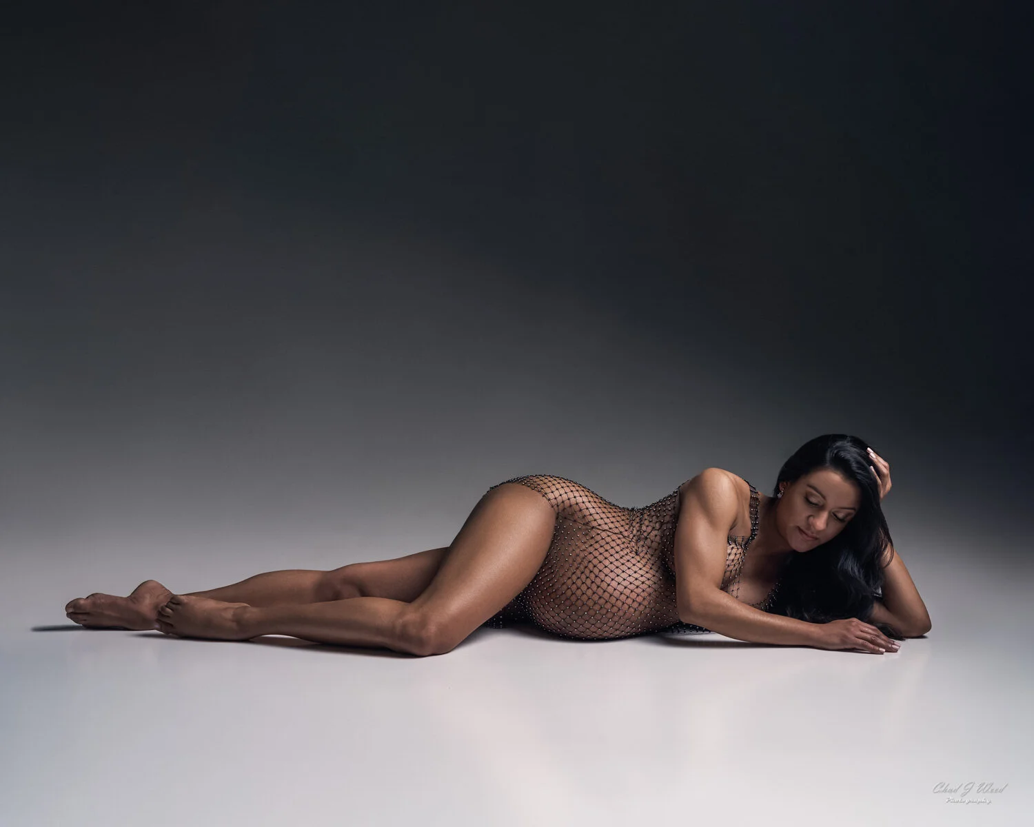 Phoenix Maternity Photographer: Pregnant women laying in a mesh bathing suit