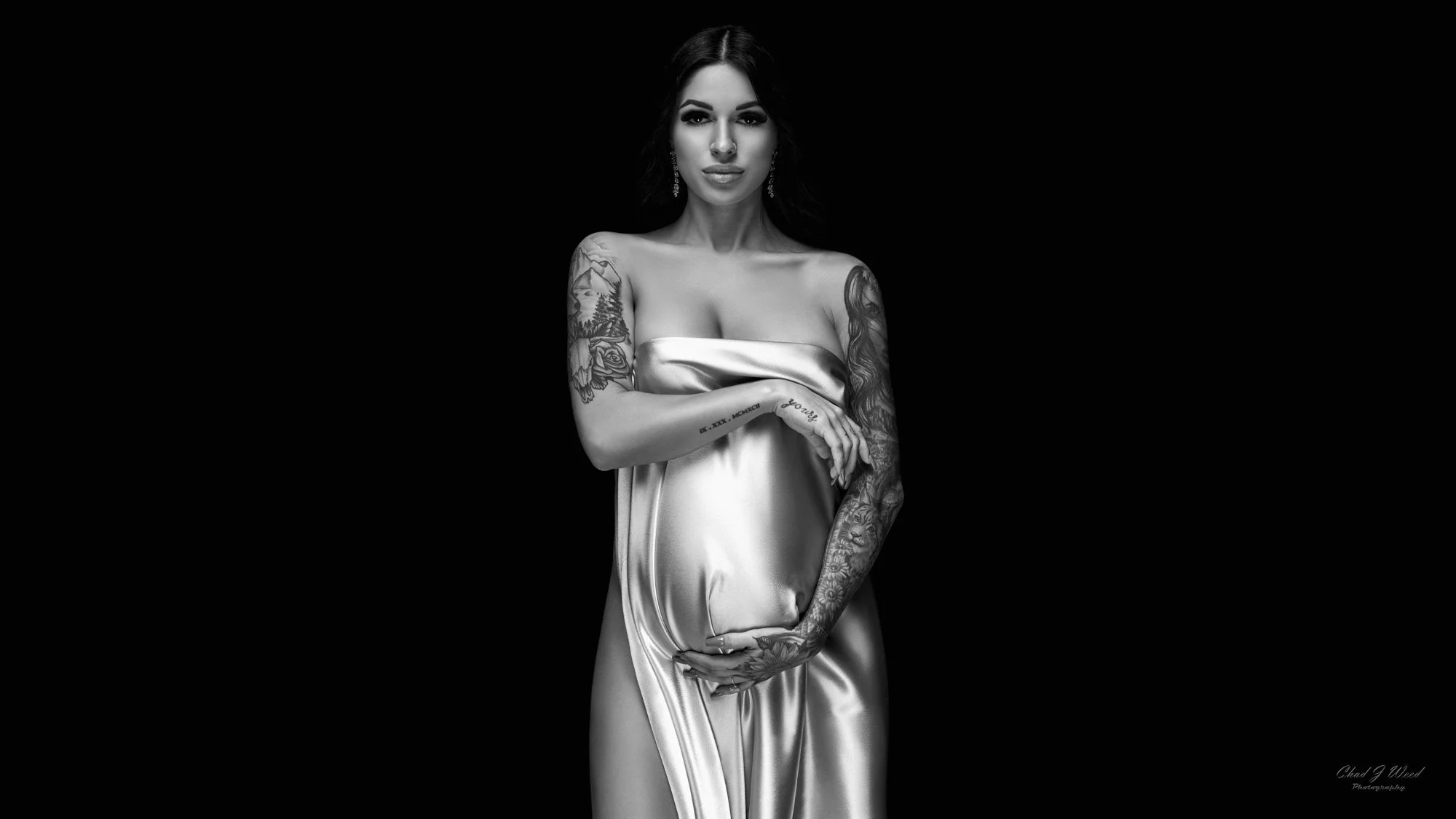 Studio maternity standing pose with silk material