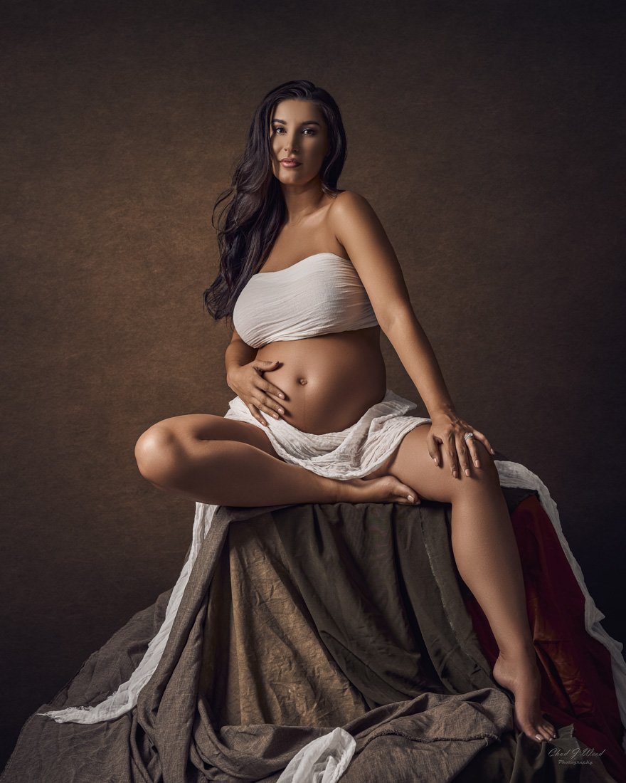 Fine Art seated pose with sheer material maternity shoot