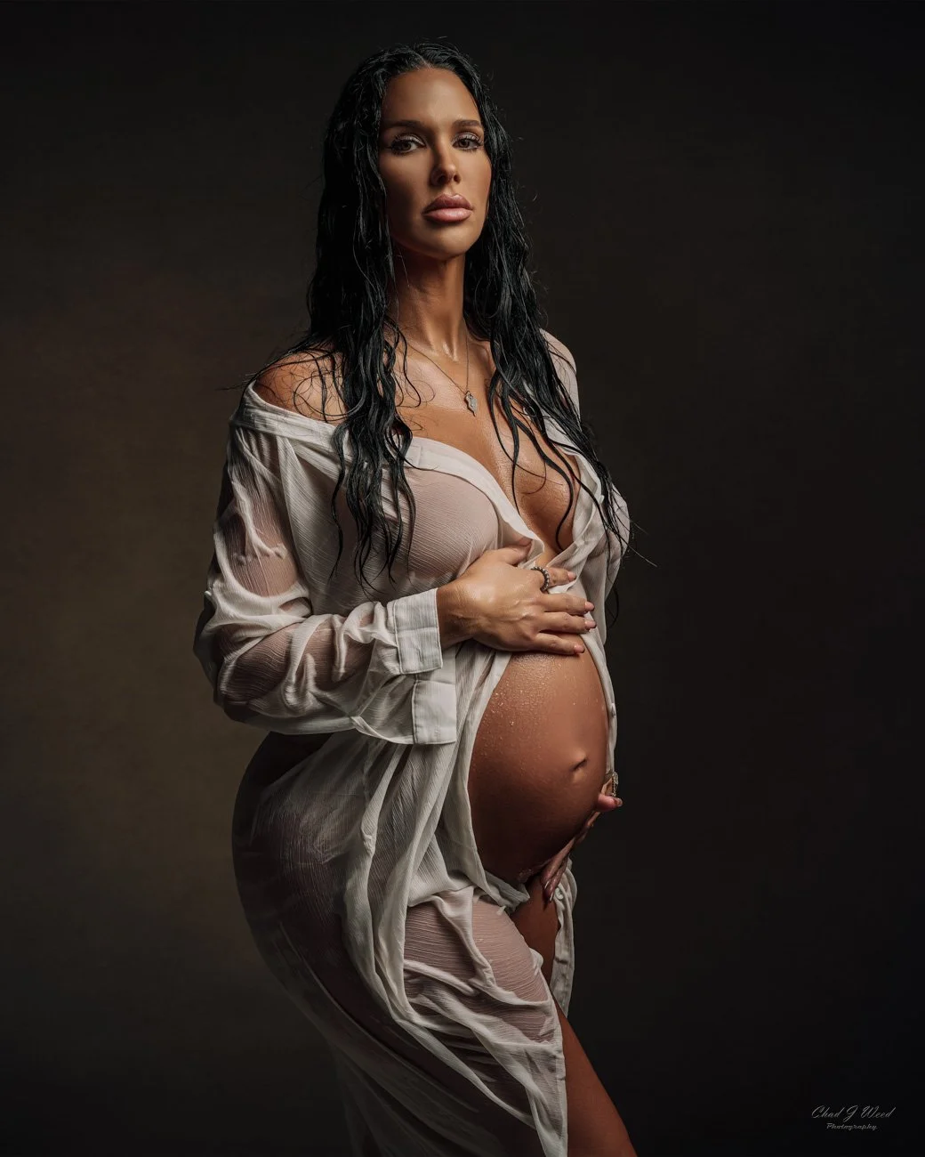 Soft and dreamy lighting on wet pregnant mom during an intimate maternity photography session