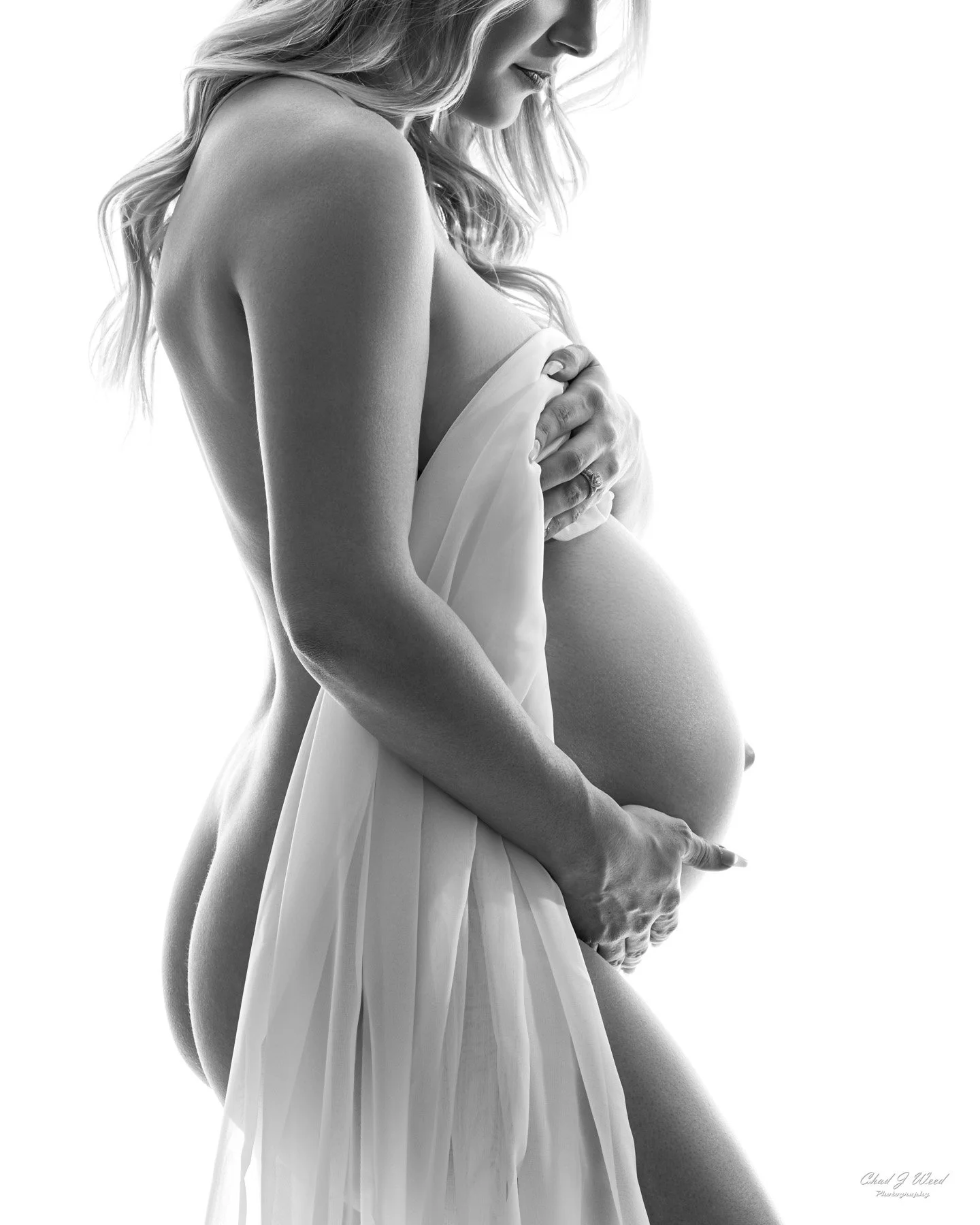 Fine art maternity photo session with soft, ethereal white backdrop