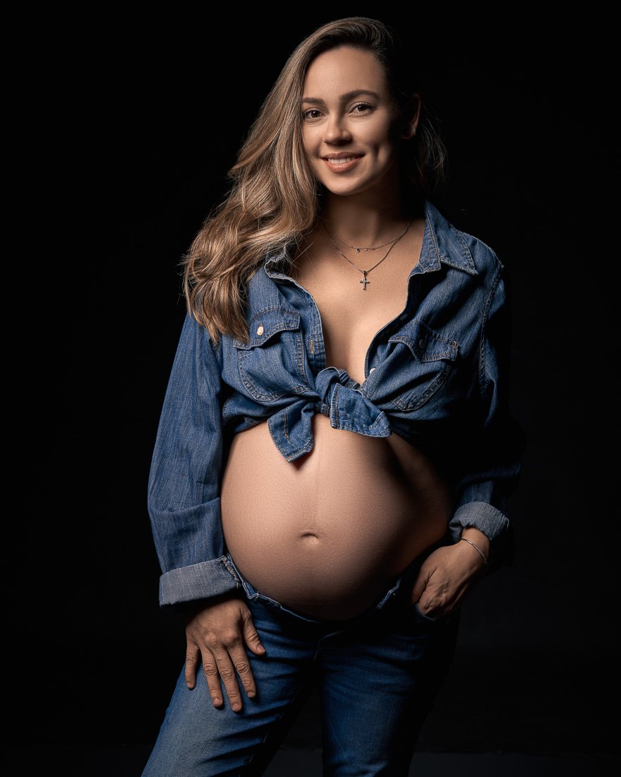 Happy pregnant woman in denim photoshoot