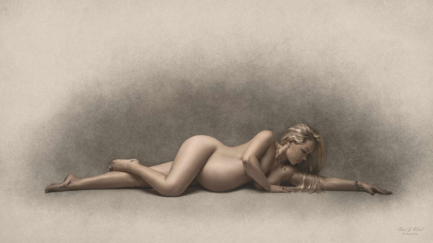 Fine Art Maternity Photographer Phoenix: Expectant mother posing with a soft, glowing light, highlighting her figure