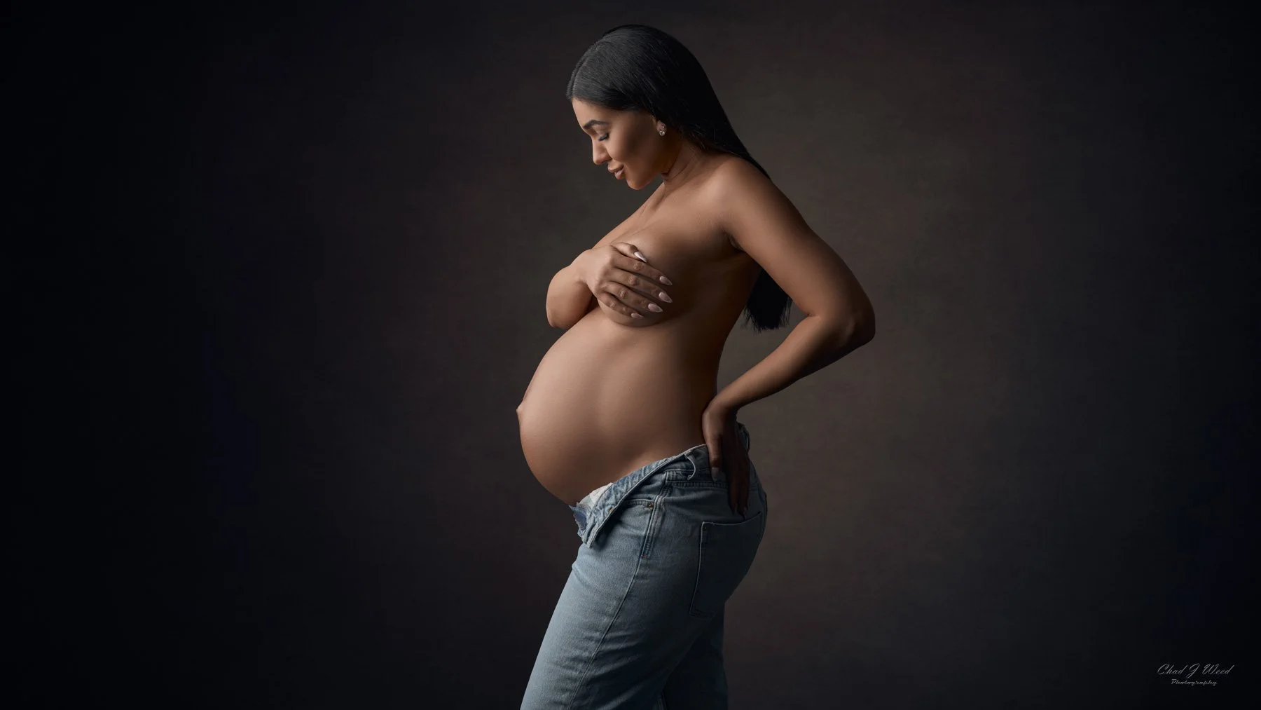 Jeans maternity photo with soft studio lighting