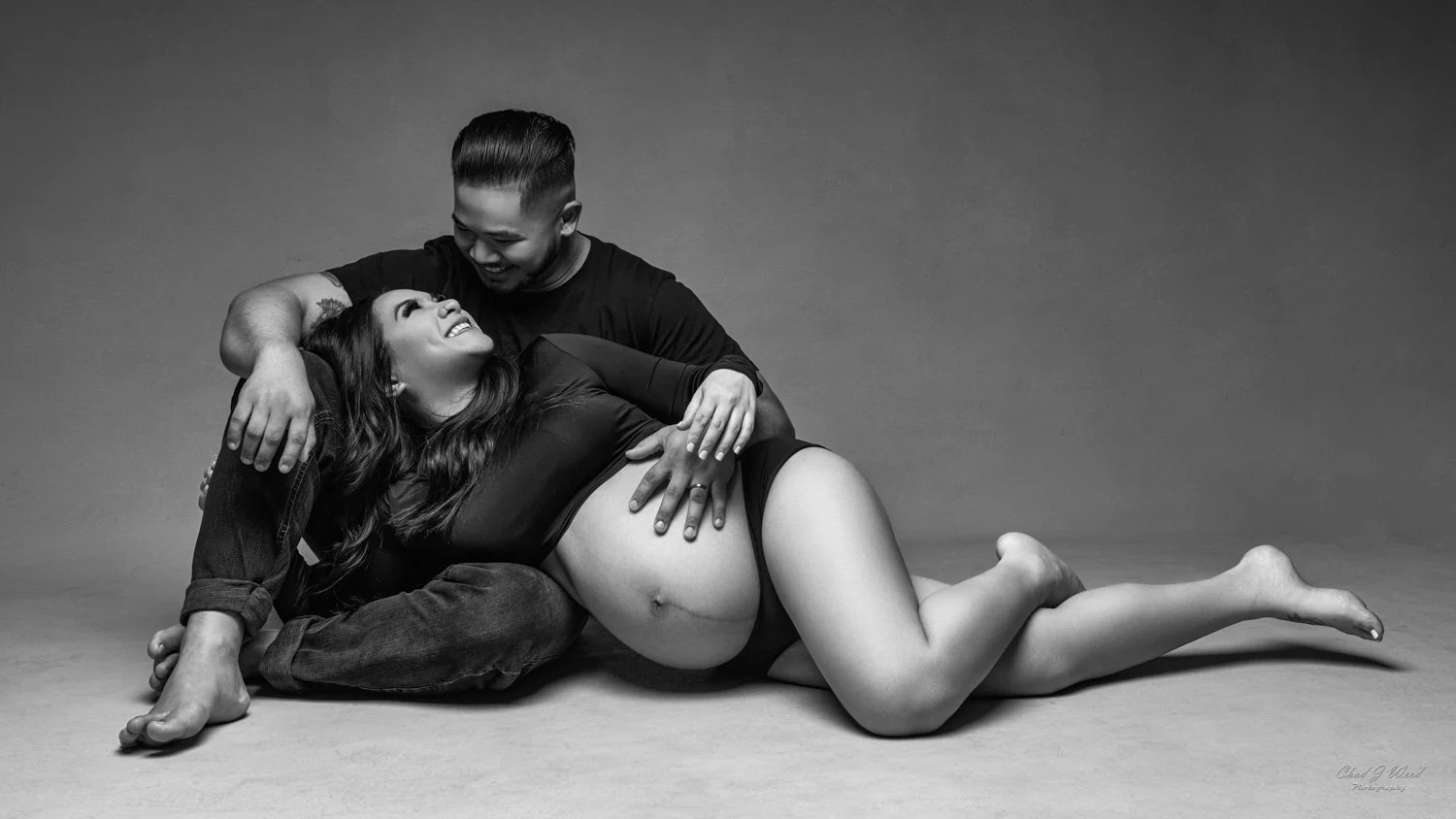 Studio maternity couples photography session celebrating pregnancy together