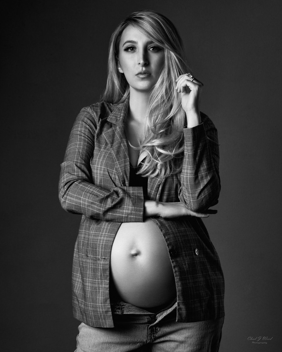 Black and white photo of mom-to-be in jeans and jacket
