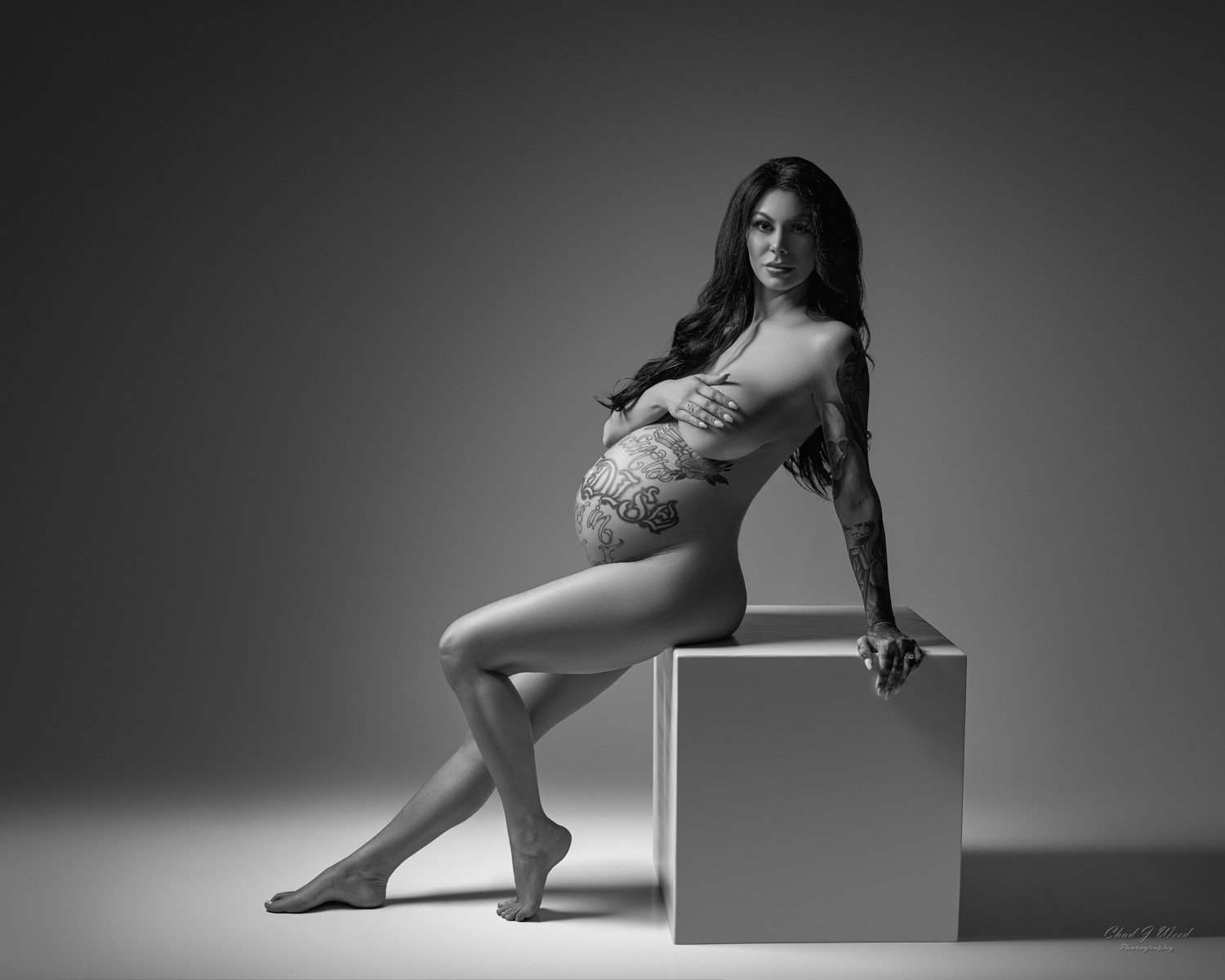 Strong and confident sitting pose during an intimate maternity boudoir photoshoot