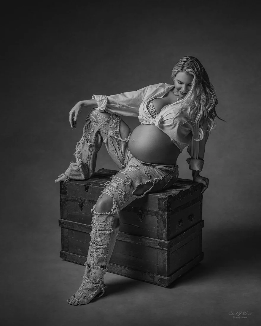 Maternity Photoshoot in Jeans: Joyful pregnancy portrait in jeans and white shirt sitting on a box