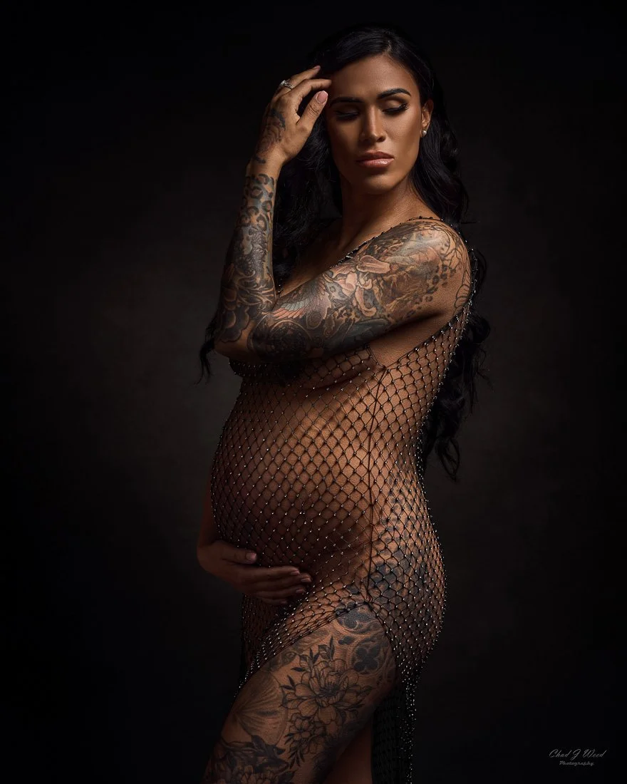 Studio boudoir maternity photo with dark background