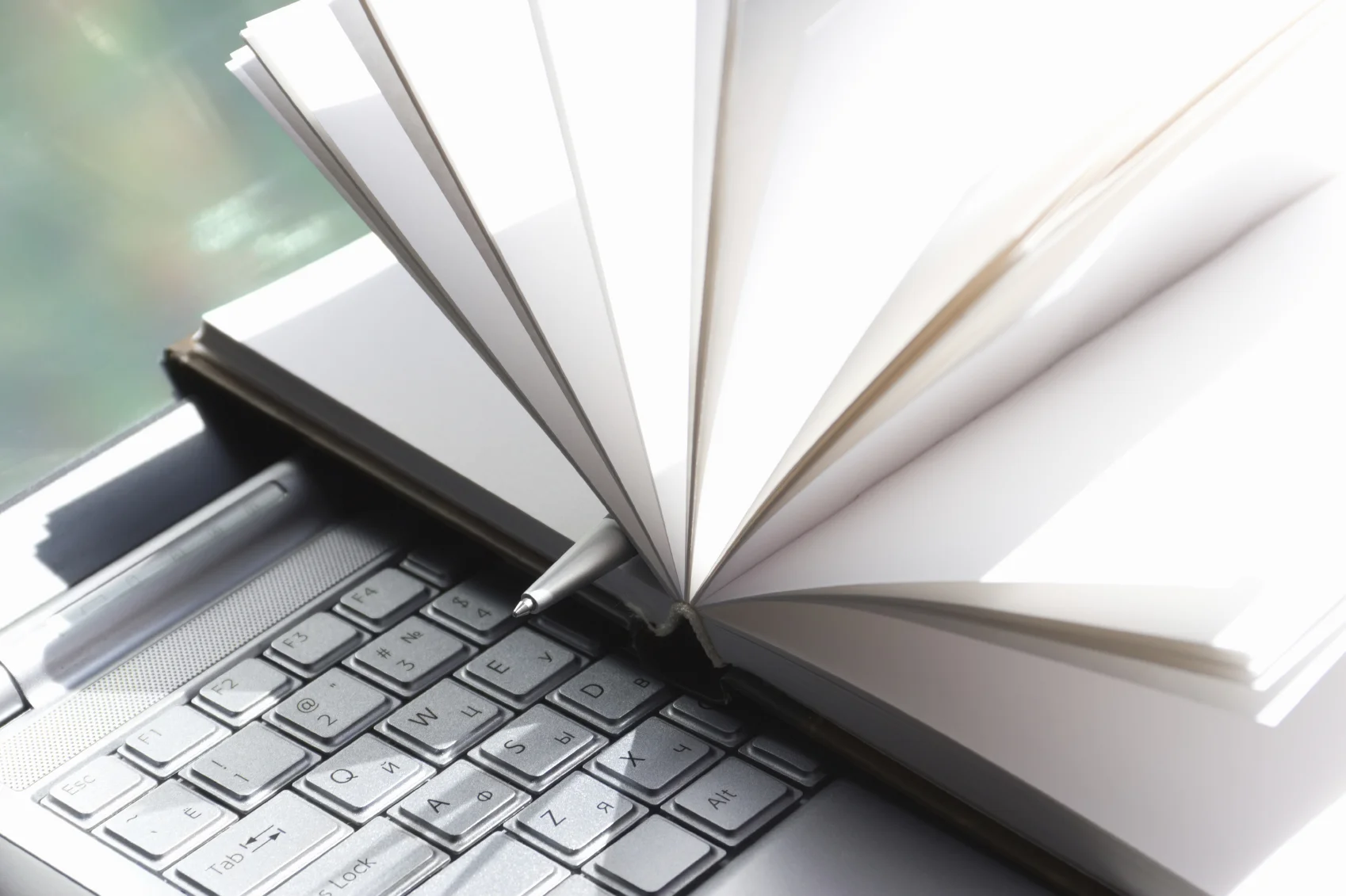 stock-photo-20738378-computer-with-notebook-and-a-pen.jpg