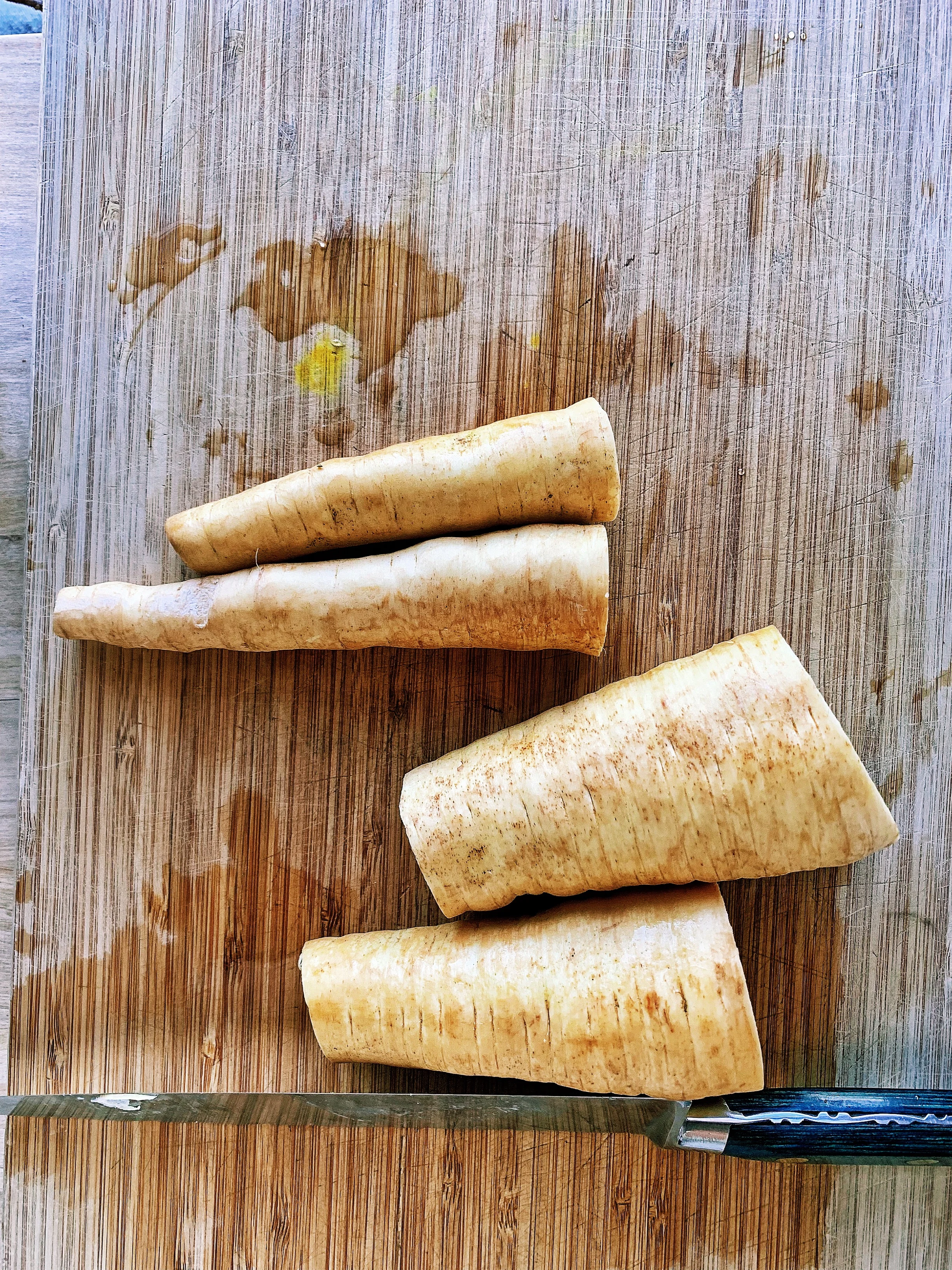 Step #3, cut the parsnips in half width-wise.