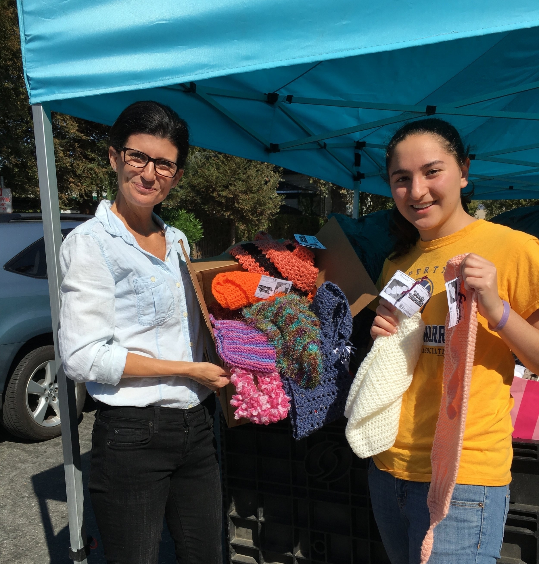 Milpitas Chapter President Dania Alkoraishi donating items to Sacred Heart Community Service