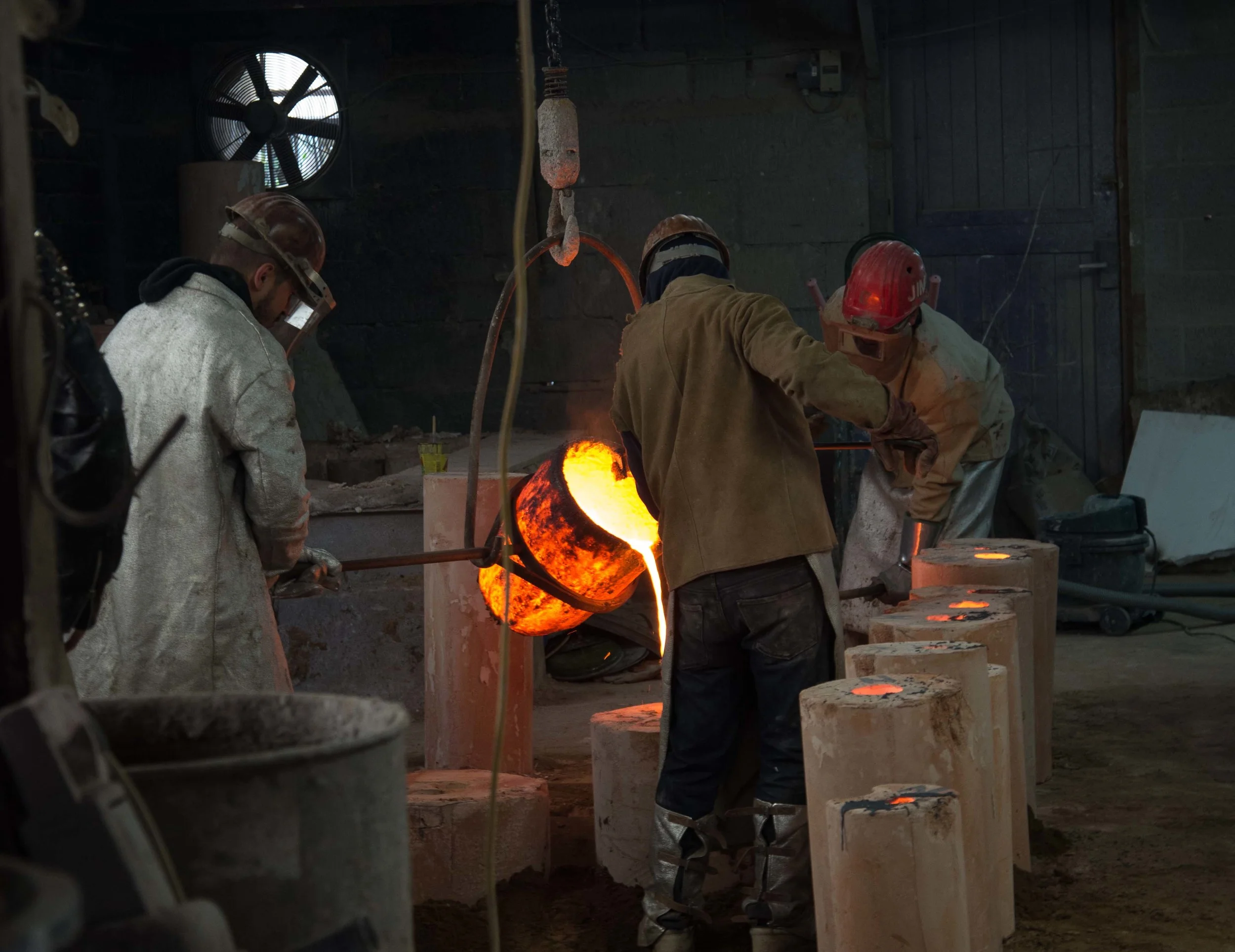 poring the liquid bronze into the mould. Critical moment...
