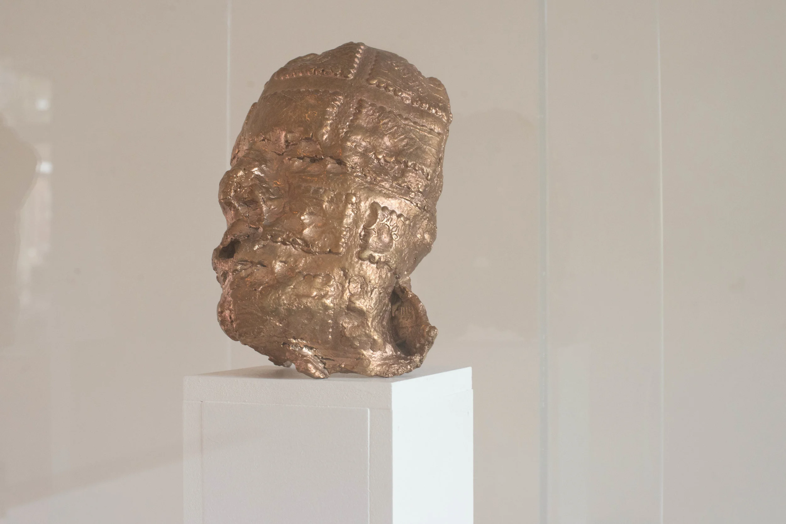 2016 bronze, plexiglass, wood 180x36x36 first clay mask I made in 2012 had cast in bronze in 2016