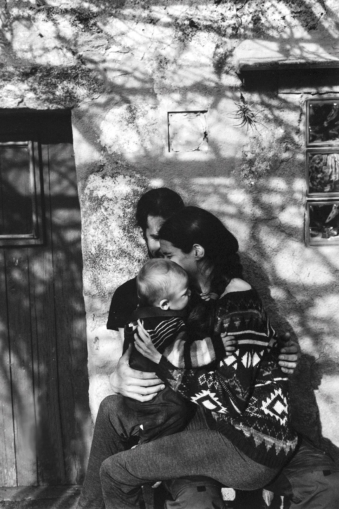  young family in front of their house 