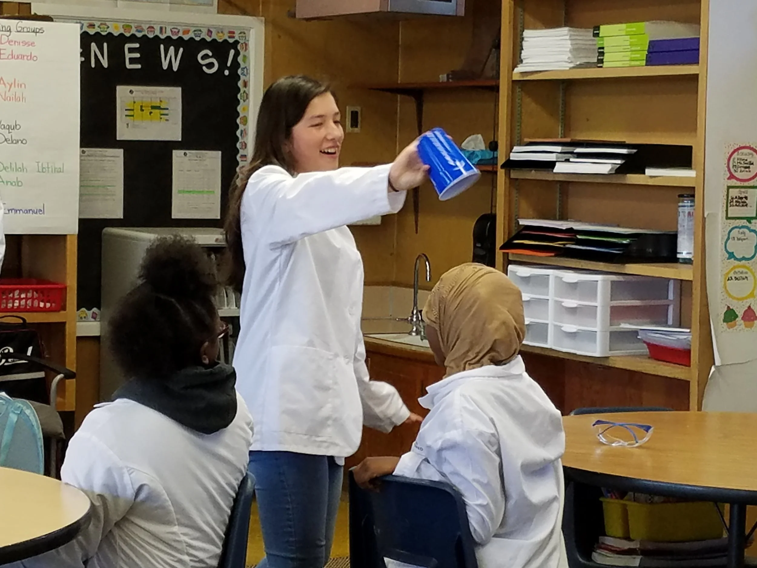 A 10th grade CAPTS student performing a chemistry magic trick for 5th graders