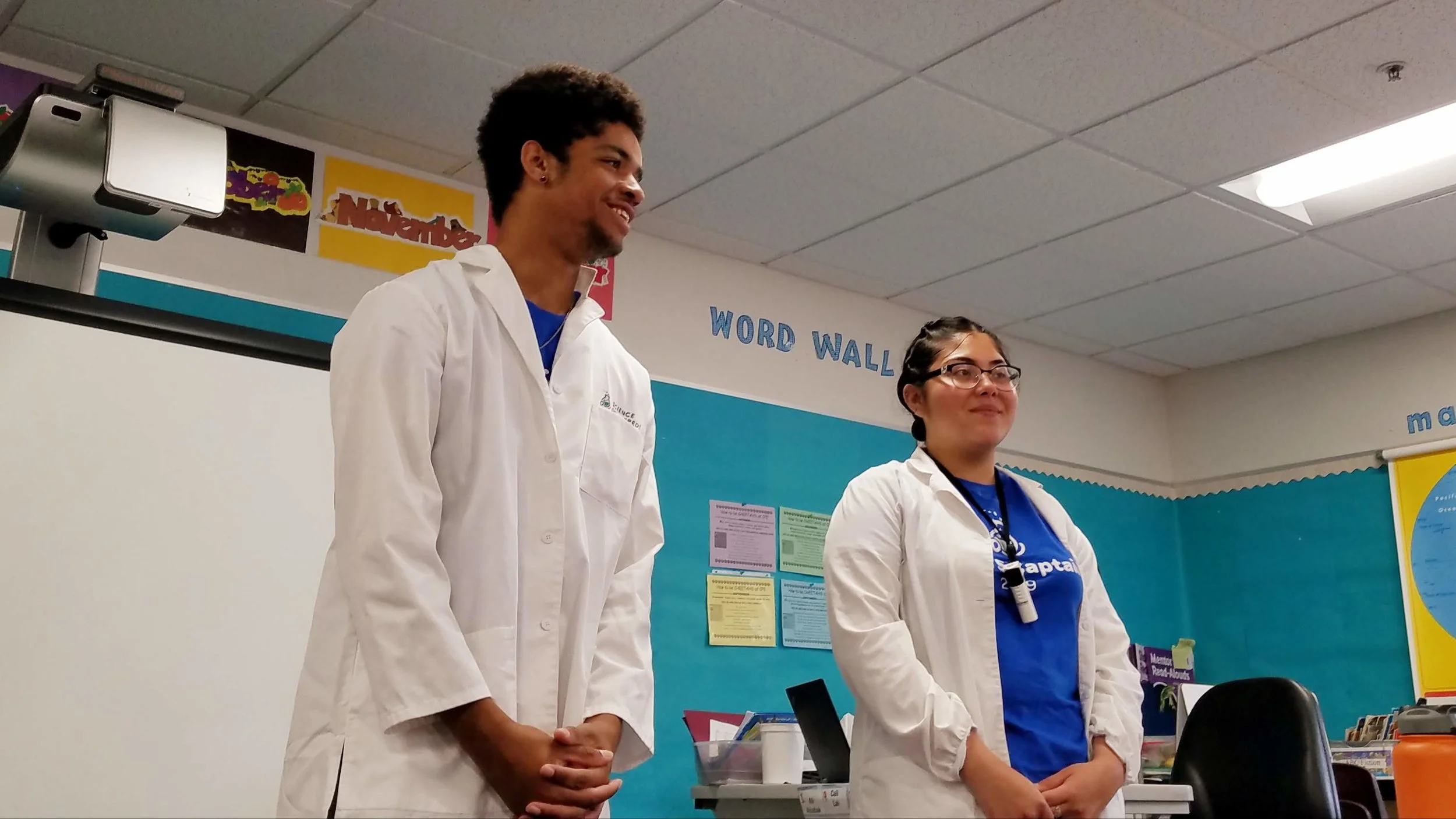 Rahmiir (left) and his partner Rosa teaching a science lab in a 1st grade classroom.