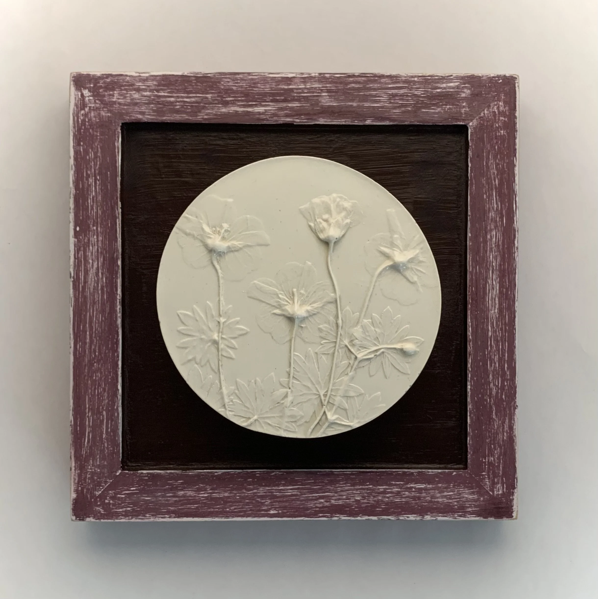  Geraniums, plaster-of-paris, milk-paint on wood frame, 6.9in x 6.9in x 0.8in (ready to hang with picture-wire on back)  Geraniums bloom vibrantly in my garden. These beauties beckoned me to capture their beauty and display them in a frame painted wi