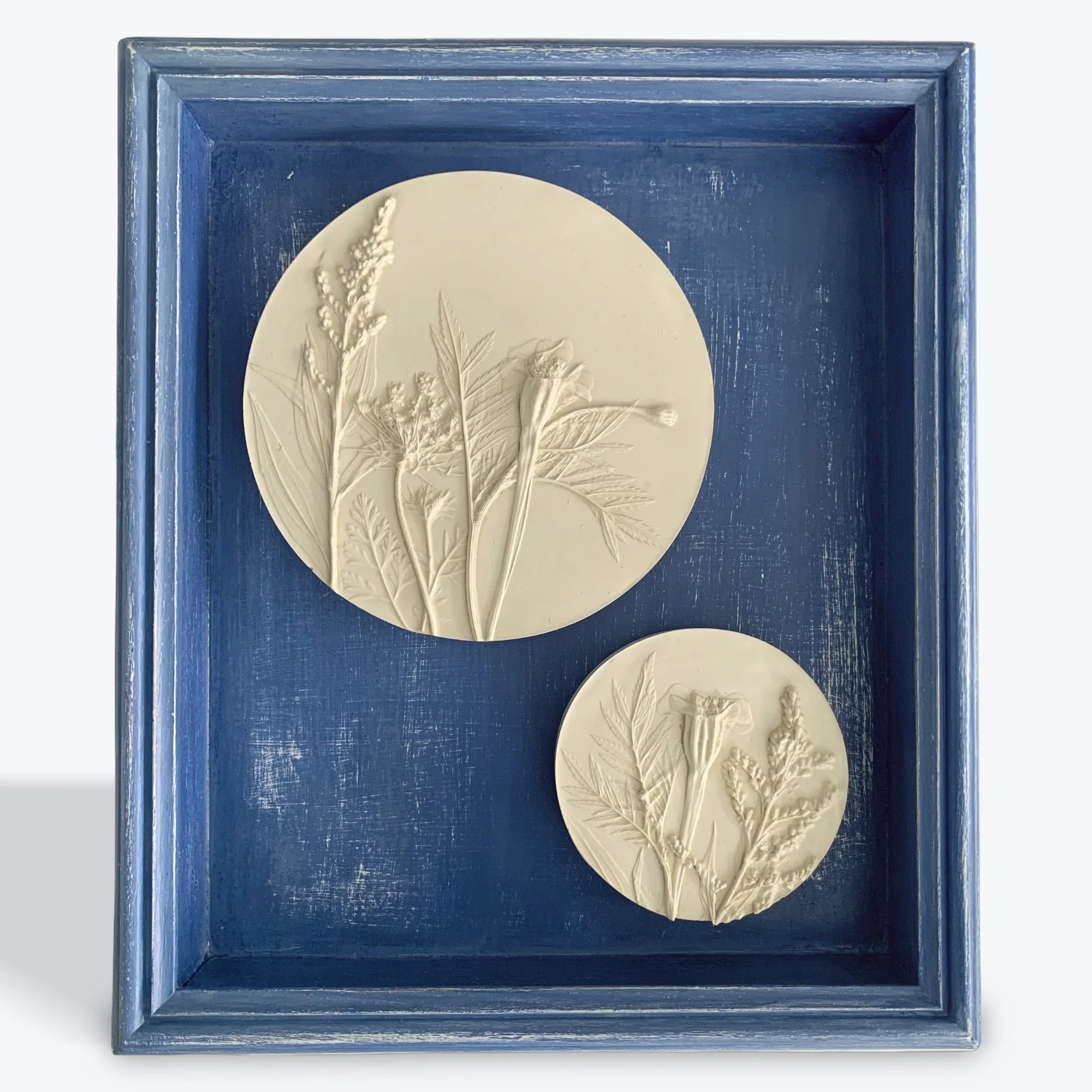  Wildflowers on Blue, hydrostone, milk-paint on repurposed wood frame, 14.5in x 12.5in x 2.25in (ready to hang with picture-wire on back)  Wildflowers impressions in the casts include: Wild Carrot (Daucus carota), Marigold (Tagetes patula), Goldenrod